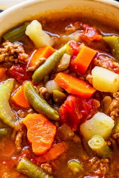 a bowl filled with meat and vegetables next to the words hamburger soup on top of it