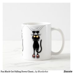 a white coffee mug with a black cat on it's front and back sides