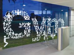 a glass wall with white writing on it