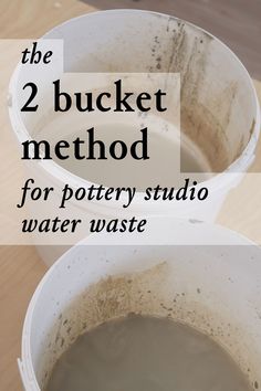 two buckets filled with water sitting on top of a wooden table next to each other