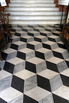 a black and white checkered floor with stairs