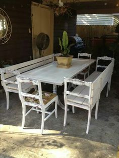 an outdoor table and chairs are painted white