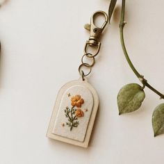 an embroidered key chain with flowers on it