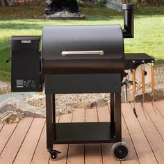 a bbq grill sitting on top of a wooden deck