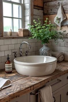 a white bowl sink sitting on top of a wooden counter