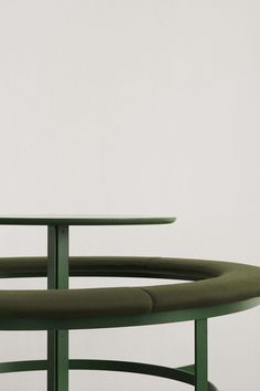 a green table sitting on top of a white floor