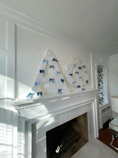 the fireplace is decorated with blue butterflies and letters that spell out acrylic on it