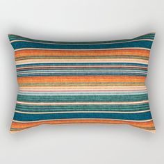 a rectangular pillow with multicolored stripes on it