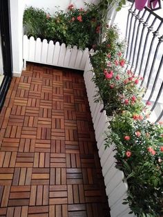 the balcony is decorated with flowers and plants