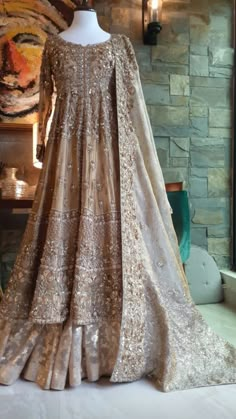 a dress on display in front of a brick wall