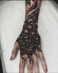 a person's hand with tattoos on it