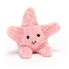 a pink teddy bear with a smile on it's face is laying in front of a white background