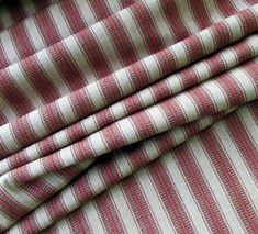 red and white striped fabric is folded on top of the other material in this close up photo