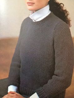 an old photo of a woman wearing a sweater