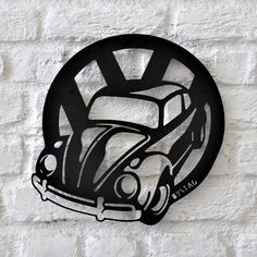 a black and white photo of a car on a brick wall with the word'vw bug'in it