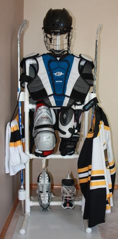 a hockey goalie's uniform and helmet are on display in the locker room