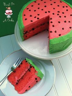 a watermelon cake on a plate with a slice missing