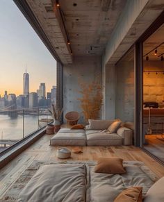 a living room filled with furniture next to a window overlooking a cityscape in the distance