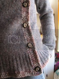 a person wearing a sweater with buttons on it