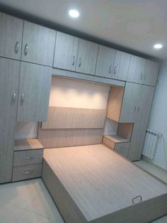 an empty room with wooden furniture and drawers