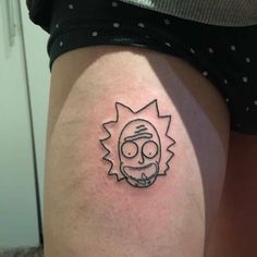 a person with a tattoo on their thigh that has a cartoon character drawn on it