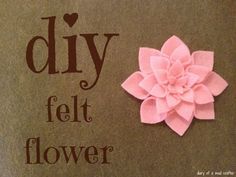 a pink flower sitting on top of a piece of paper that says diy felt flower