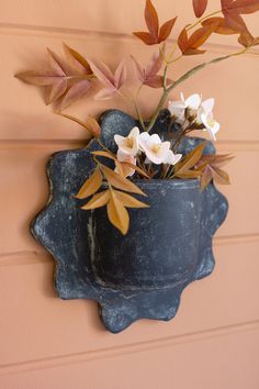 a potted plant hanging on the side of a wall