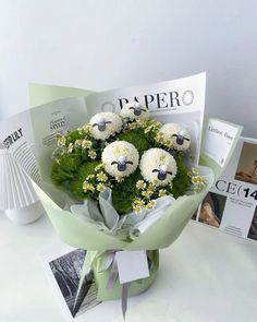 a bouquet of daisies and carnations in the shape of sheep