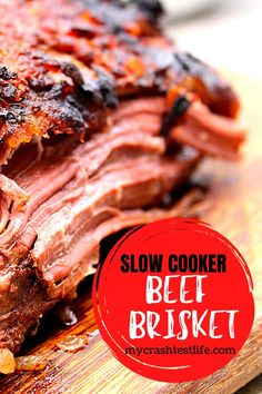 slow cooker beef brisket on a cutting board with text overlay that says slow cooker beef brisket