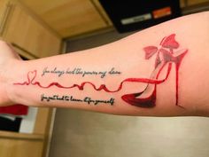 a woman's arm with a quote on it