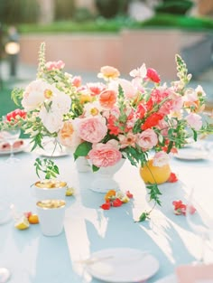 a table with plates and flowers on it