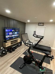 a home gym with treadmills, exercise bike and flat screen tv