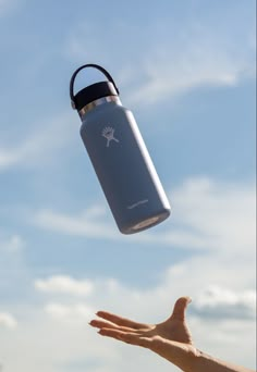 a hand holding a water bottle in the air