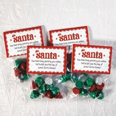 four small candy candies with santa's name on them