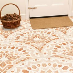 a basket full of pine cones sitting on the floor next to a door with a door mat