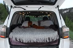 the back end of a white van filled with furniture