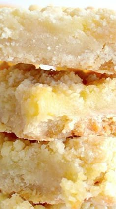 three pieces of cake sitting next to each other on a white plate with lemons in the background