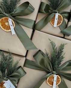 several wrapped presents with orange slices and green ribbons