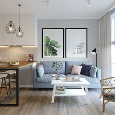 a living room filled with furniture next to a kitchen and dining room table on top of a hard wood floor