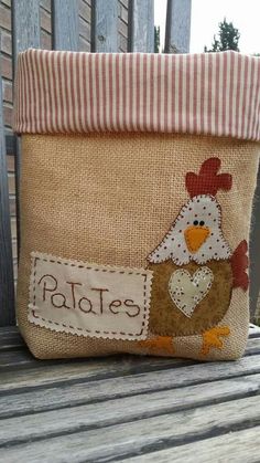 a brown and white chicken sitting on top of a wooden bench next to a bag