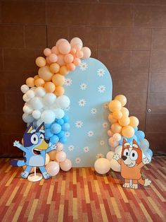 the balloon arch is decorated with cartoon characters