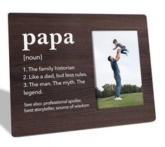 a wooden frame with an image of a man holding a child in his arms and the words papa on it