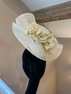 Daisy is an elegant and fun statement hat. Perfect for race day or a wedding this hat is made from a beautiful ivory parisissal straw and finished with a large oversized flower. Chic Beige Straw Hat For Garden Party, Elegant Cream Straw Hat For The Beach, Elegant Cream Straw Hat For Beach, Elegant Cream Boater Hat For Beach, Elegant Beige Straw Hat With Structured Crown, Chic Structured Crown Hat For Kentucky Derby, Formal Summer Beige Straw Hat, Spring Beige Hat For Formal Occasions, Spring Formal Beige Hat