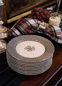 a stack of plates sitting on top of a wooden table