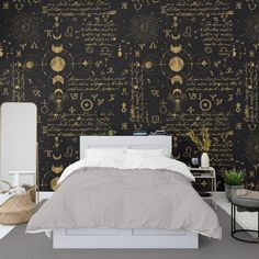 a bed sitting under a black and gold wallpaper