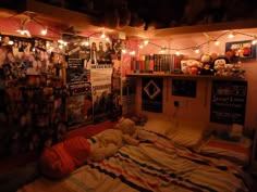 a bedroom with lights strung from the ceiling and posters on the wall