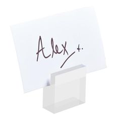 a piece of paper with the word alex written on it next to a white box