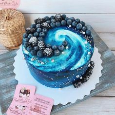 a blue and white swirl cake sitting on top of a table