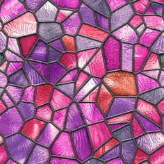 a close up view of a stained glass window with pink and purple squares on it