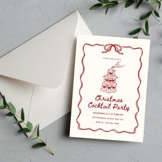 a card with a christmas tree on it next to an envelope and some greenery